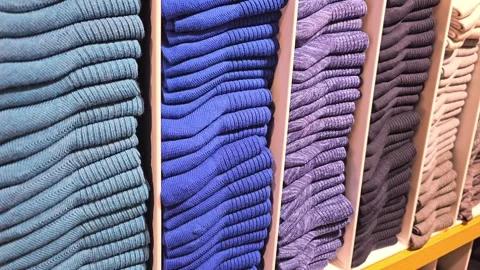 Stacks of folded socks in various shades of blue, purple, and beige Stock Footage 300299305