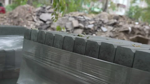 Stacks of fresh sidewalk paving blocks stand in courtyard Stockbeeldmateriaal 327807510