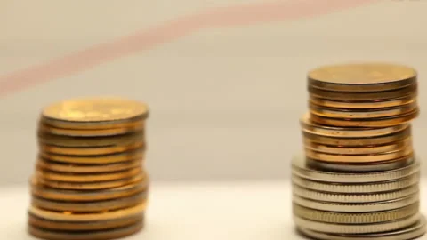 Stacks of golden coins increasing in value, representing financial growth and Stock Footage 304318281
