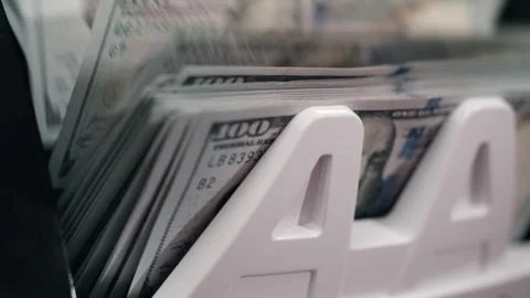 Stacks of hundred-dollar bills arranged in a white money holder, showcasing the Stock Footage 333978920
