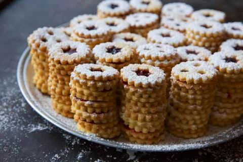 Stacks of jammy shortbread biscuits with icing sugar Stock Photos