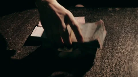 Stacks of money fall onto the table Stock Footage 284443701