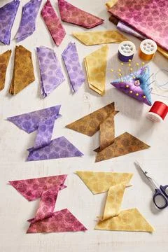 Stacks of multi-colored pieces of fabric, pieces of fabric sewn in the shap.. Stock-Fotos