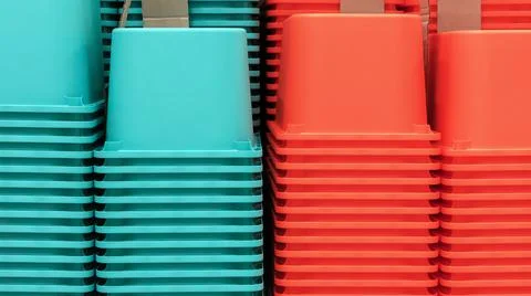 Stacks of multi-colored plastic containers for storing household items. Stock Photos