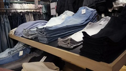 Stacks of new blue, white and black jeans Stock-Footage 311069336