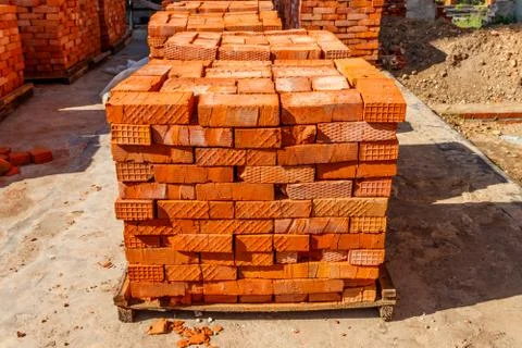 Stacks of new red brick at construction site Stock Photos