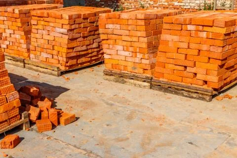 Stacks of new red brick at construction site Stockfoto's