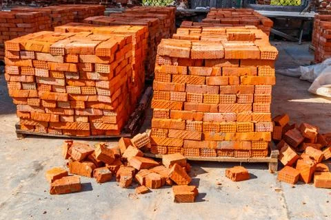 Stacks of new red brick at construction site 스톡 사진