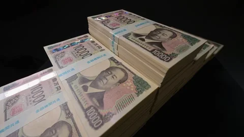Stacks of new yen banknotes on black background Stock Footage 336765711