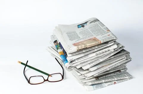 Stacks of newspapers that need to be read for business and financial information Stock Photos