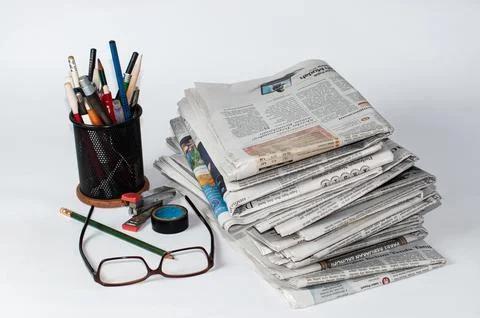 Stacks of newspapers that need to be read for business and financial information Stock Photos
