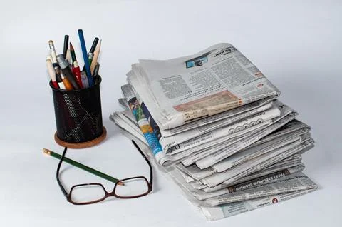 Stacks of newspapers that need to be read for business and financial information Stock Photos
