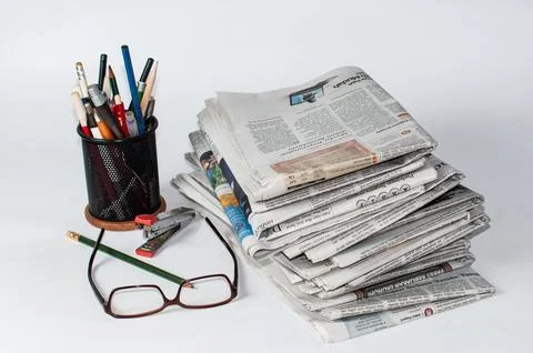 Stacks of newspapers that need to be read for business and financial information Stock Photos