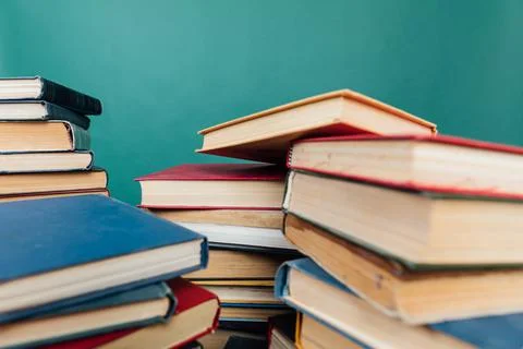 Stacks of old books for learning in the library on a green background 스톡 사진