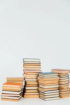 Stacks of old books in study library on white background Stock Photos
