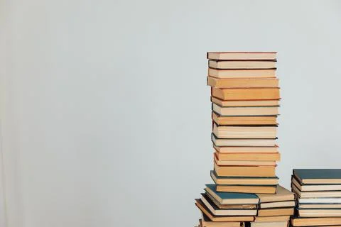 Stacks of old books in study library on white background Stock Photos
