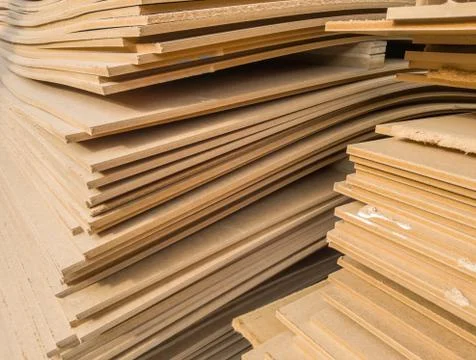 Stacks of old MDF of poor quality. Stock Photos
