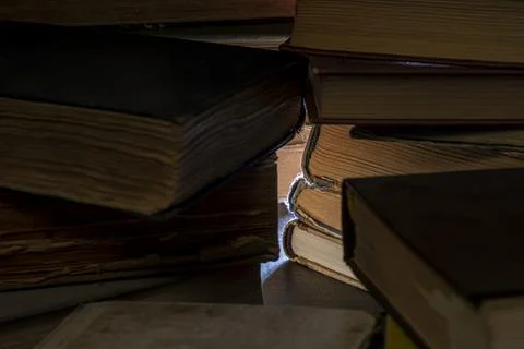 Stacks of old multi-format books with scuffs Stock Photos