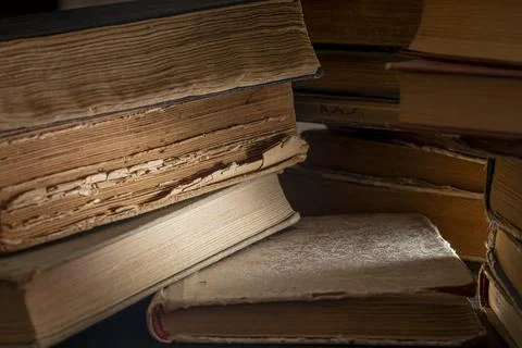 Stacks of old multi-format books with scuffs Stock Photos