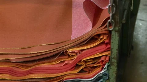 Stacks of Orange Textile Fabrics Stored Inside Factory Warehouse Stock Footage 328643541