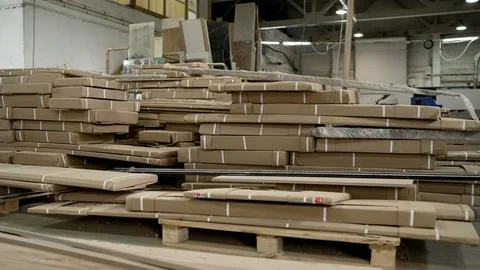 Stacks of packaged goods on pallets in a warehouse Stock Photos