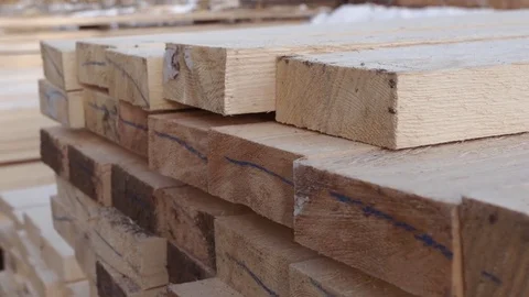 Stacks of packed lumber plank lying in yard of woodwork facility Stockbeeldmateriaal 85212593