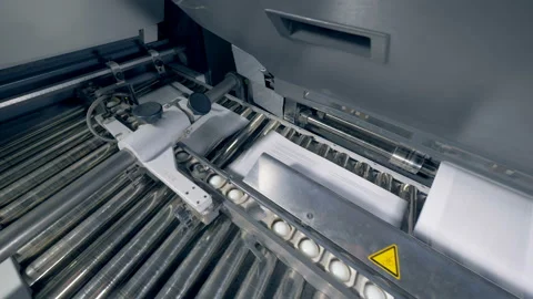 Stacks of paper on an automated conveyor, close up. Stock Footage 104225549