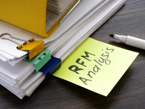Stacks of papers with RFM analysis Recency Frequency Monetary. Foto stock