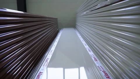 Stacks of plastic panels dark and light with branding Stock Footage 306671139