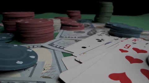 Stacks of Poker Chips, cards and Cash on Green Felt Table Stock Footage 279368650