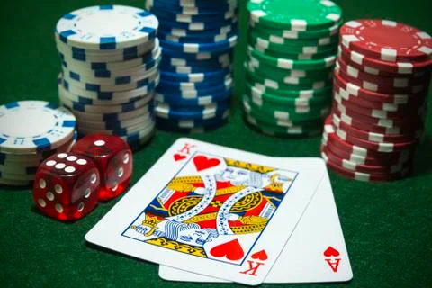 Stacks Poker chips pair dice playing cards face up. Stock Photos