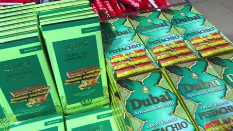 Stacks of popular Dubai chocolate bars and other sweets at a pastry shop. Stock Footage 311940872