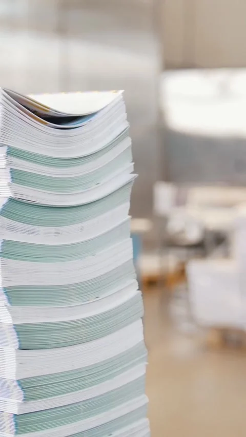 Stacks of printed magazines in front of working process in the typography Stock Footage 346706605