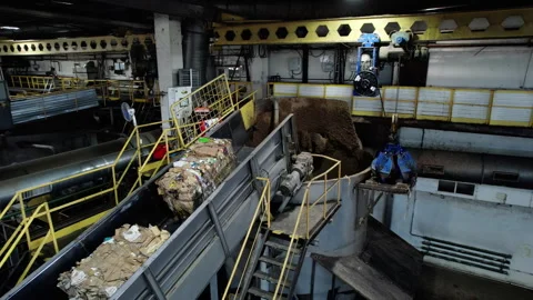 Stacks of raw waste paper flow on conveyor into recycling machine Vídeo Stock 290524177