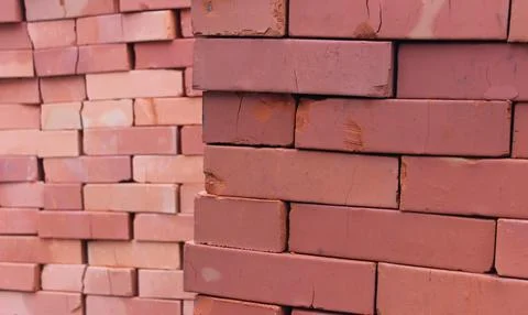 Stacks of red bricks after long storage in the open air Foto stock