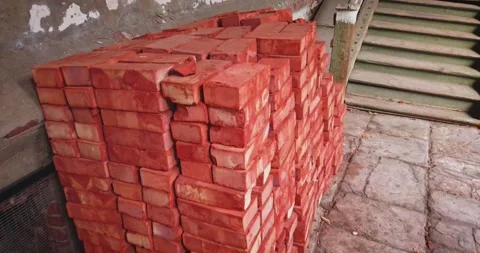 Stacks of red bricks for construction purpose in old house yard Vídeo Stock 157935704