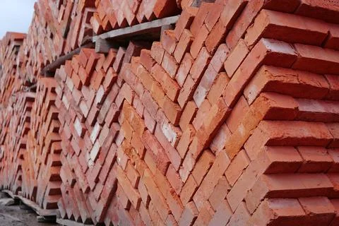 Stacks of red bricks in construction supermarket Stock Photos