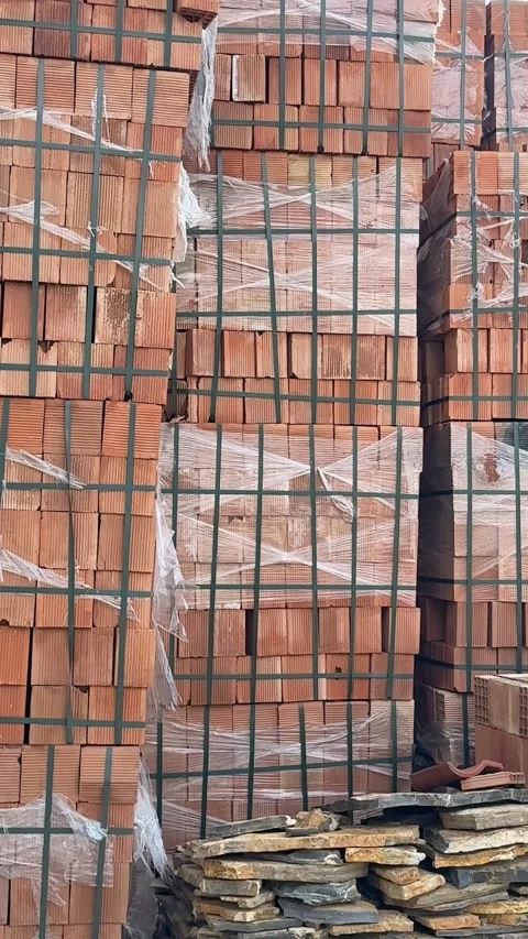 Stacks of red bricks wrapped in plastic and secured with straps at construc.. Stock Footage 330800623