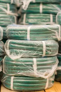 Stacks of rolls yellow pvc plastic pipe on the counter in the store. Sale Hos Stock Photos