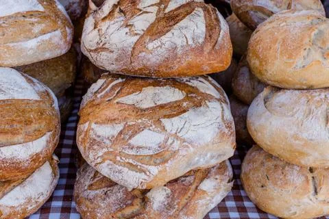 Stacks of rustic sourdough bread on table, close up Stock Photos