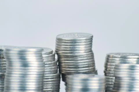 Stacks of silver coins on white background. Stock Photos