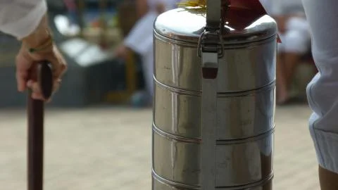 Stacks of silver container being held above Foto stock