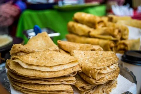 Stacks of tasty thin folded pancakes on plate Stock Photos