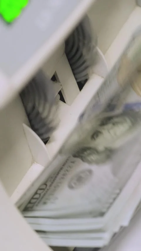 Stacks of US dollars being processed and counted in an automatic money counting Stock Footage 317737201