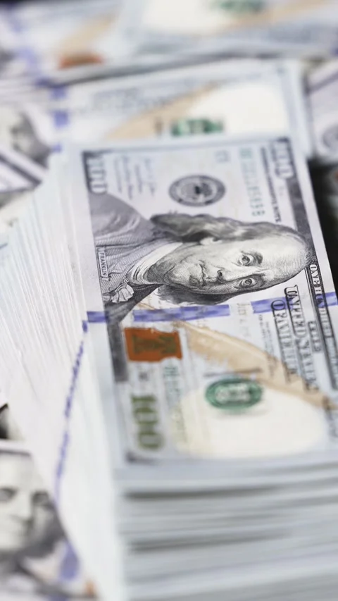 Stacks of U.S. hundred dollar bills arranged in various positions, showcasing Stock Footage 328124753