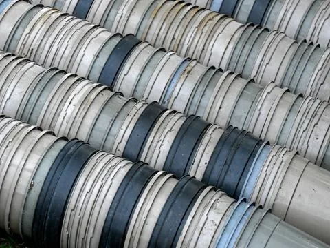 Stacks of used grey plastic flower pots at a nursery Foto stock