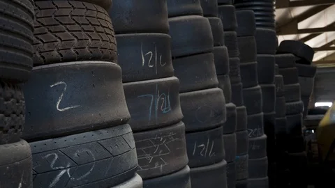 Stacks of Used Slick and Tread Race Car Tires Stock Footage 107769773