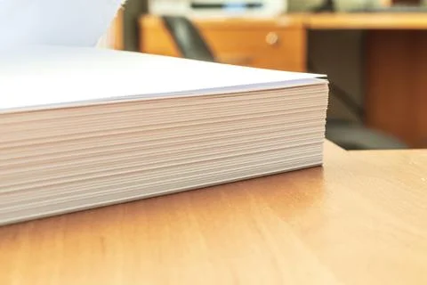 Stacks of white papers work large stacks of papers stacked together. On a d.. Stock Photos