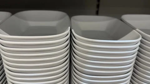 Stacks of white square plates in neat arrangement, perfect for kitchenware .. Stock Footage 331147337