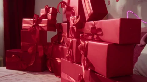 Stacks of Wrapped Red Gift Boxes Tied with Matching Ribbons Stock Footage 326621335